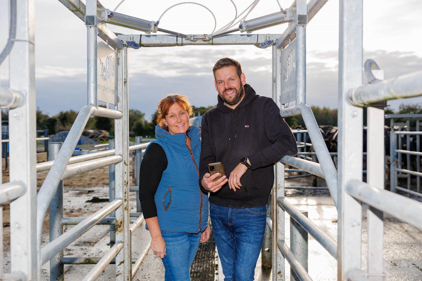 A man and a woman standing in a metal structure